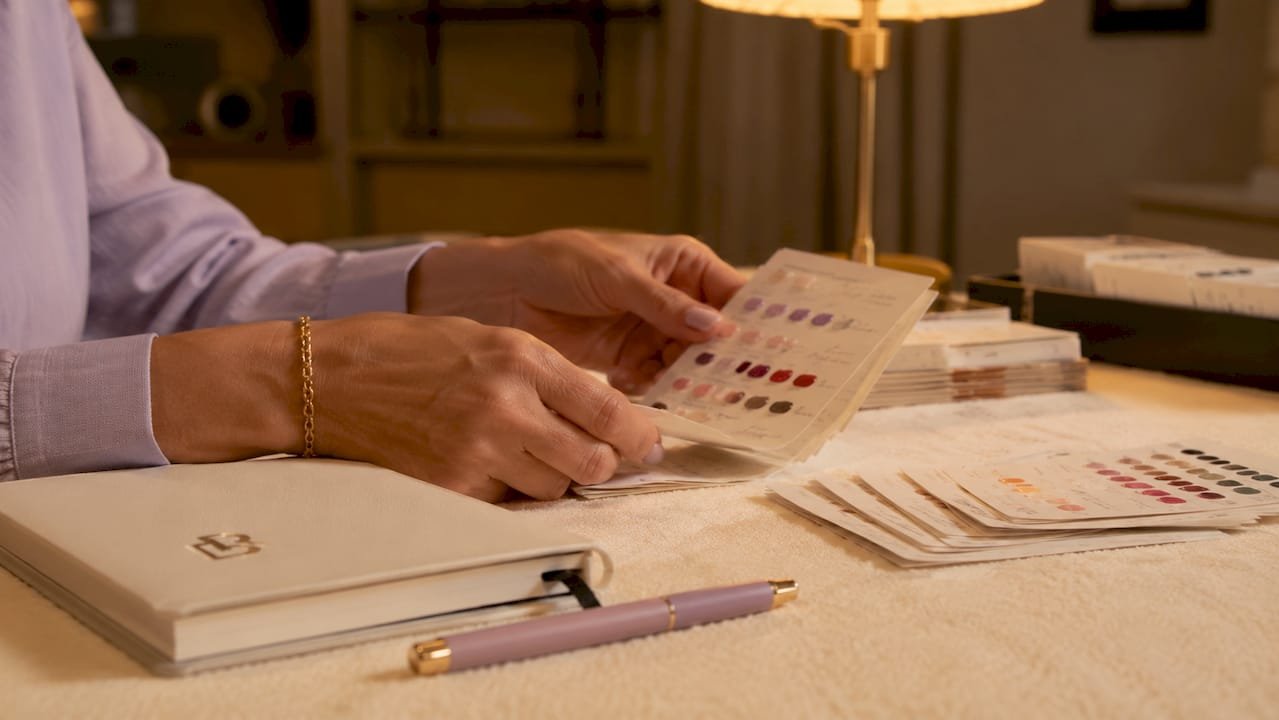Hands sorting physical client record cards