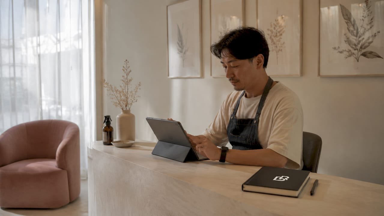 Hairstylist checking online reviews and bookings